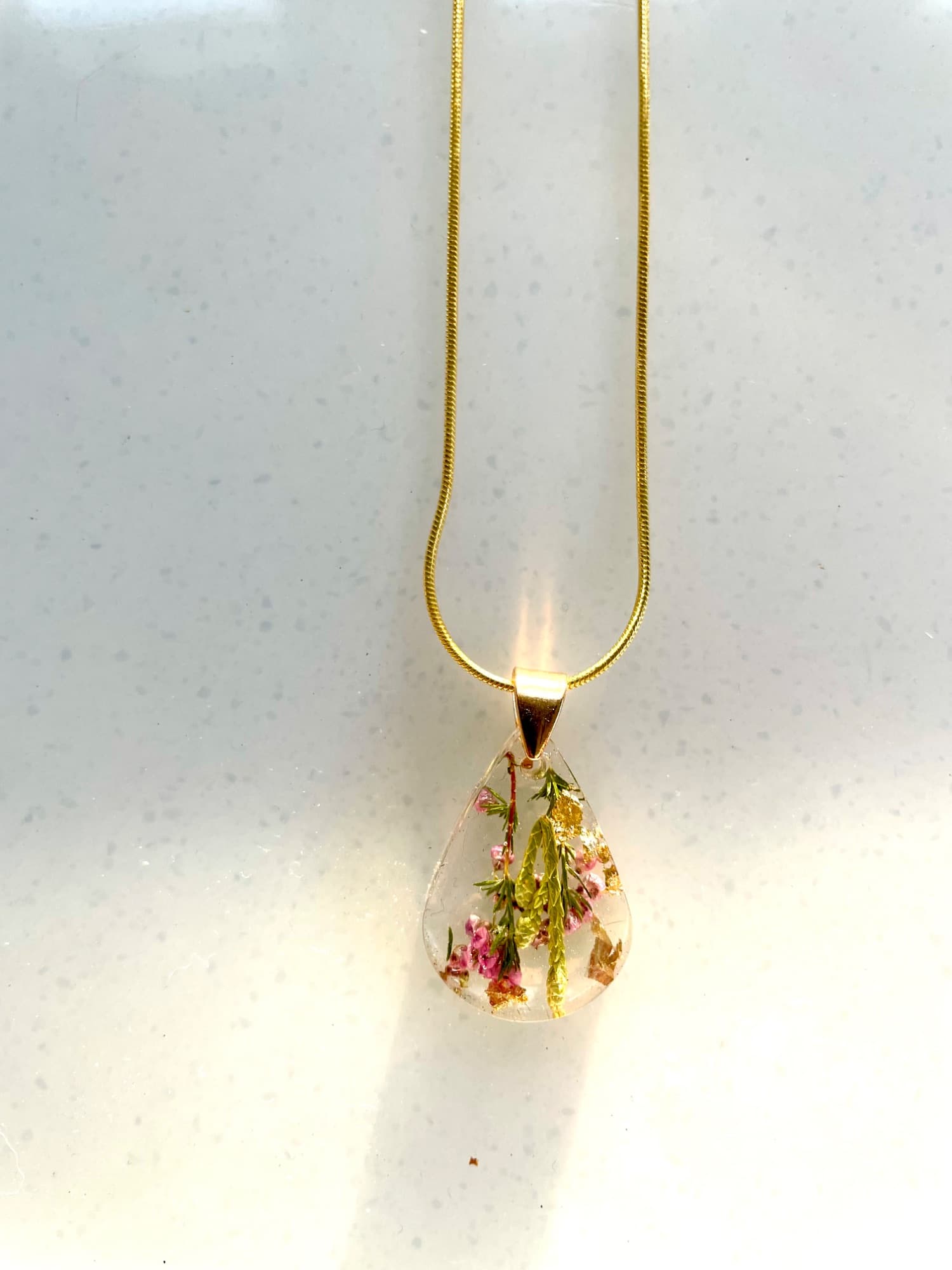 Botanical & gold leaf resin necklaces.